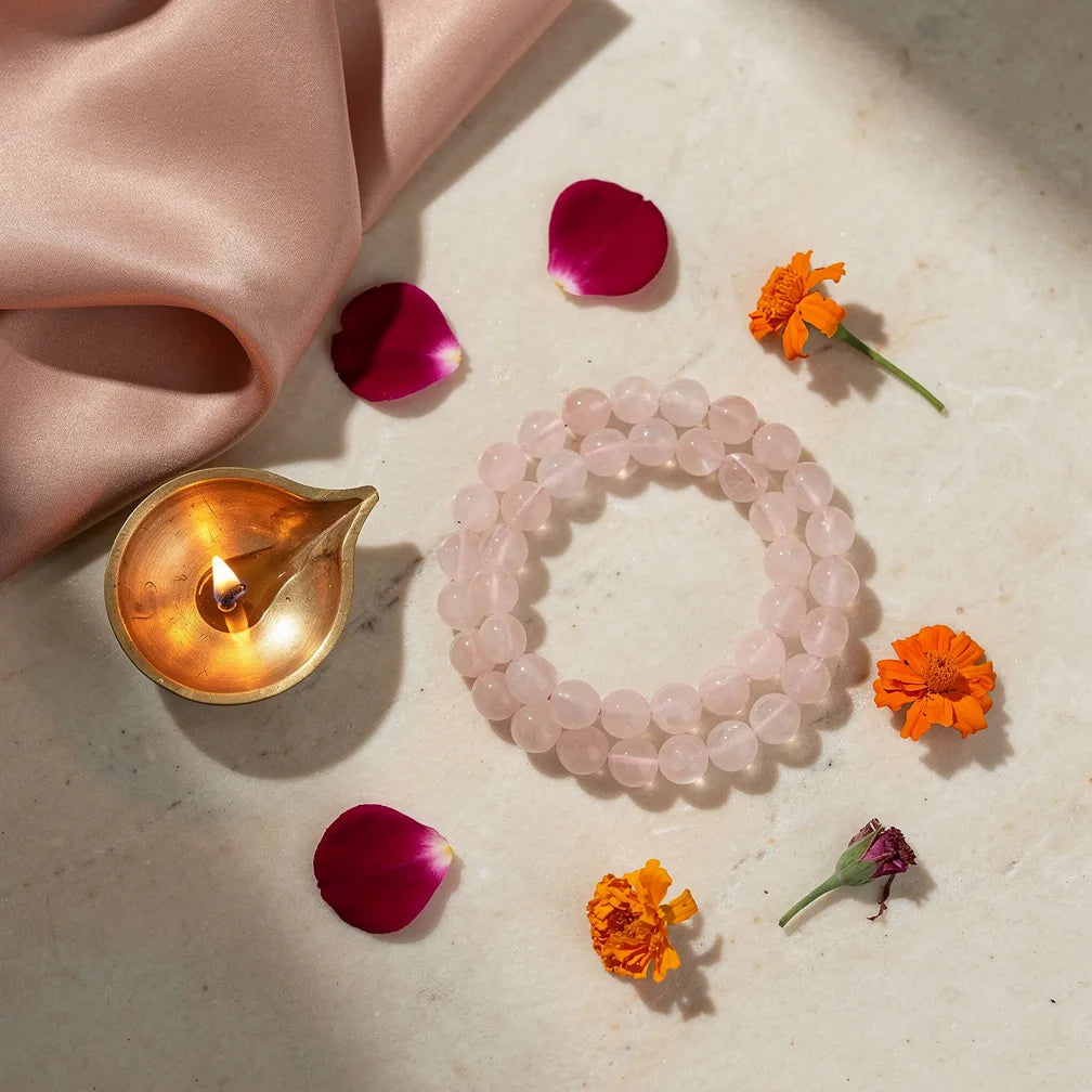 Rose Quartz Band with diya and petals — ritual flat-lay | Salico