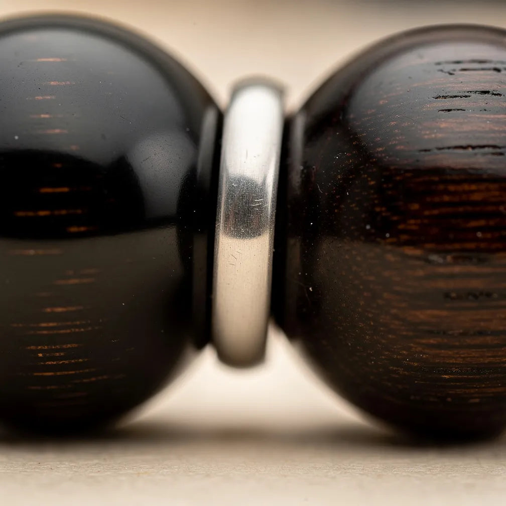 Ebony bead and silver cap craftsmanship close-up | Salico