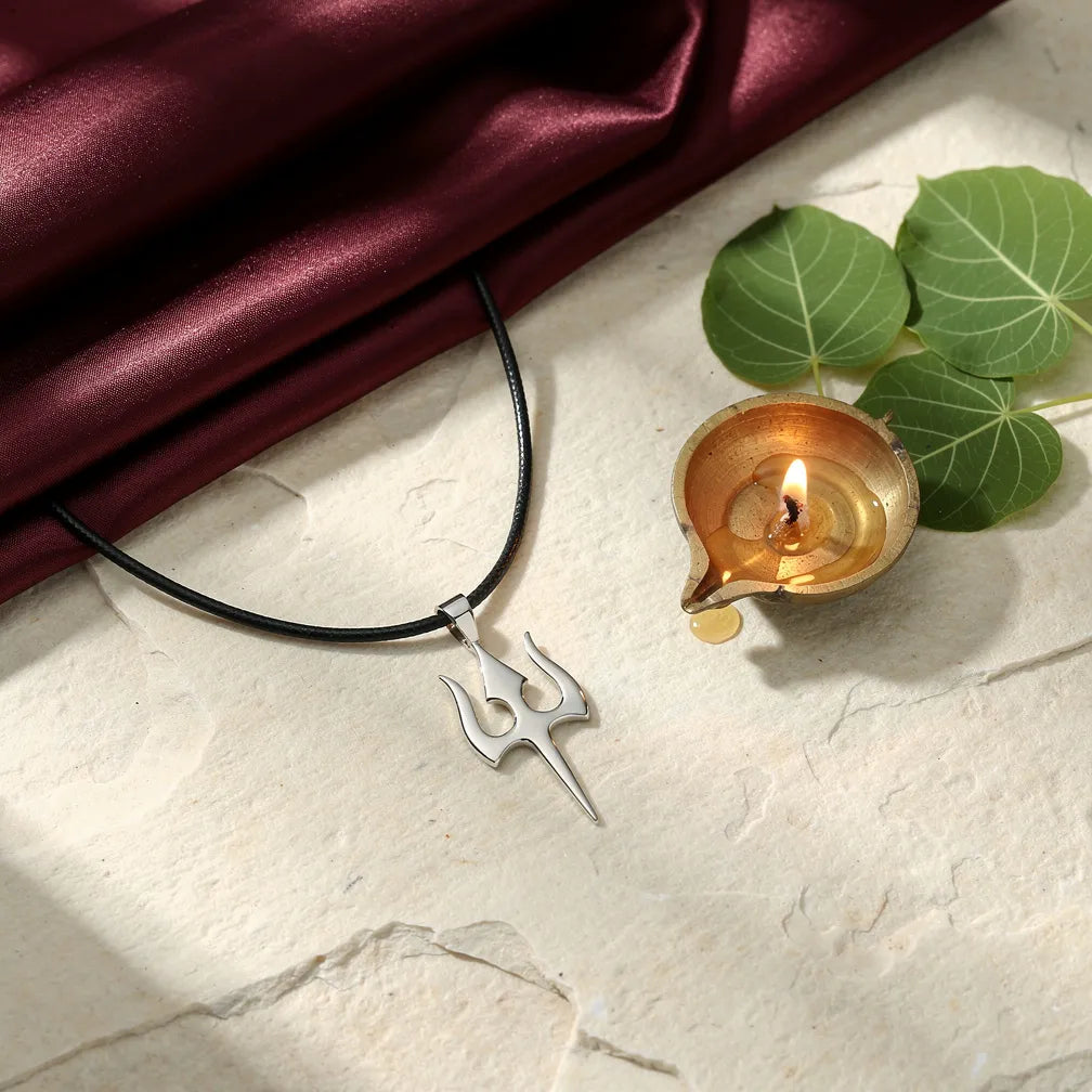 Trishul Pendant with diya and bilva — ritual flat-lay | Salico