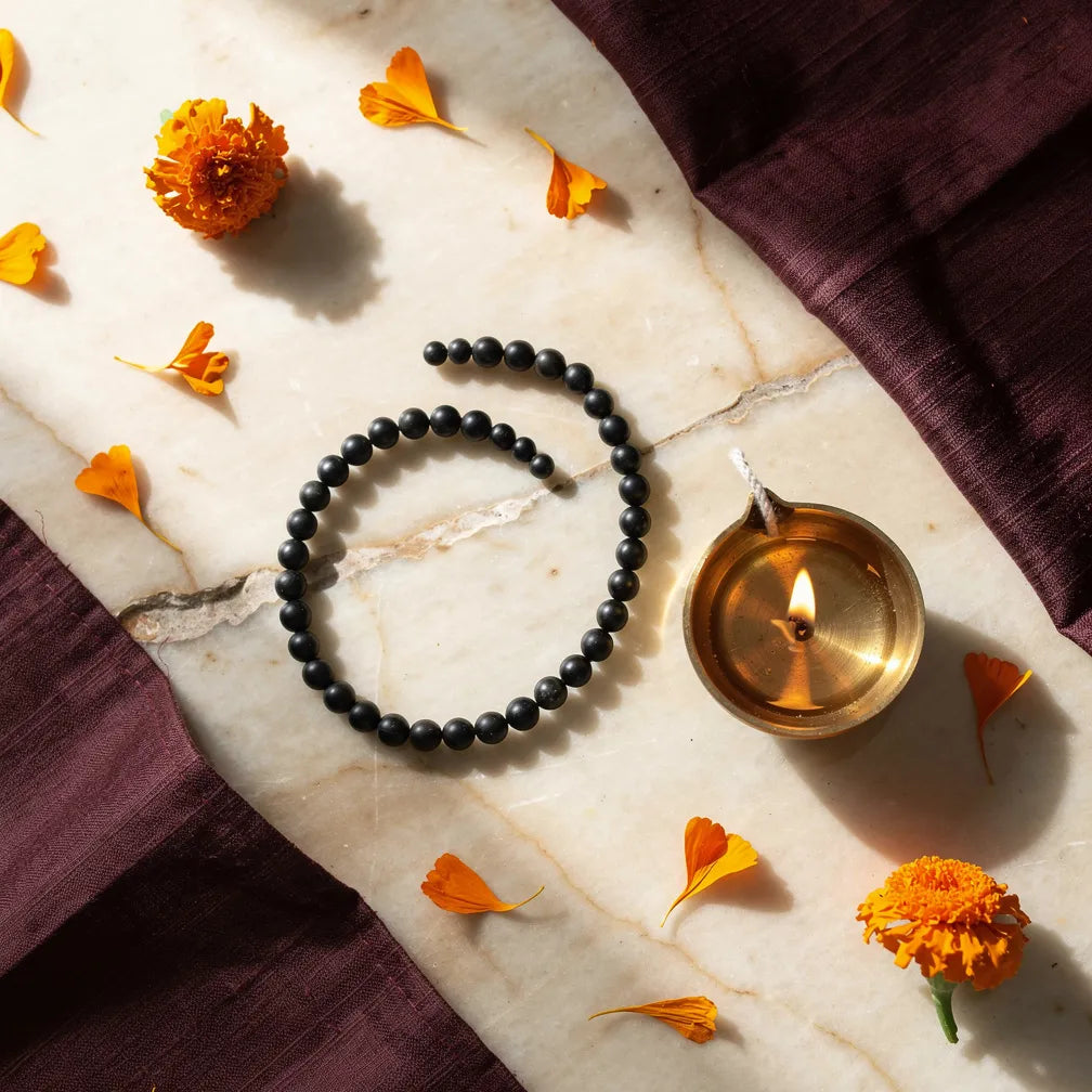 Karungali Slim Bracelet with diya and marigold — ritual flat-lay | Salico