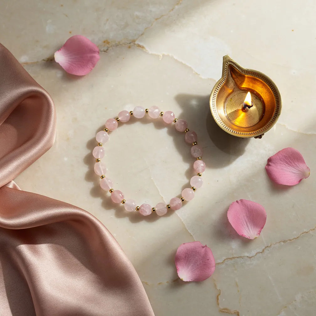 Dainty Rose Quartz Bracelet with diya and petals — ritual flat-lay | Salico
