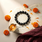 Karungali Classic Bracelet with diya and marigold — ritual flat-lay | Salico