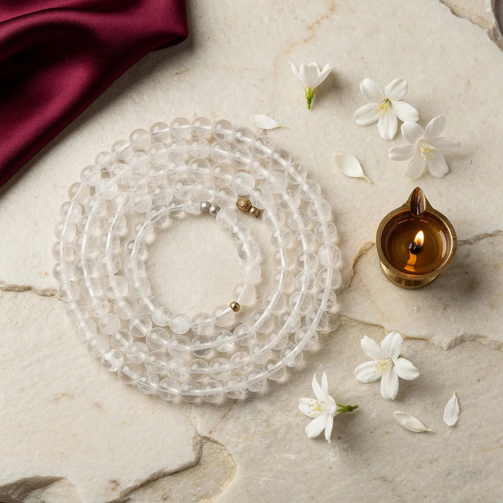 Sphatik Mala with diya and jasmine — ritual flat-lay | Salico