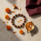 Silver Eclipse Rudraksha Bracelet with diya and marigold — morning ritual | Salico