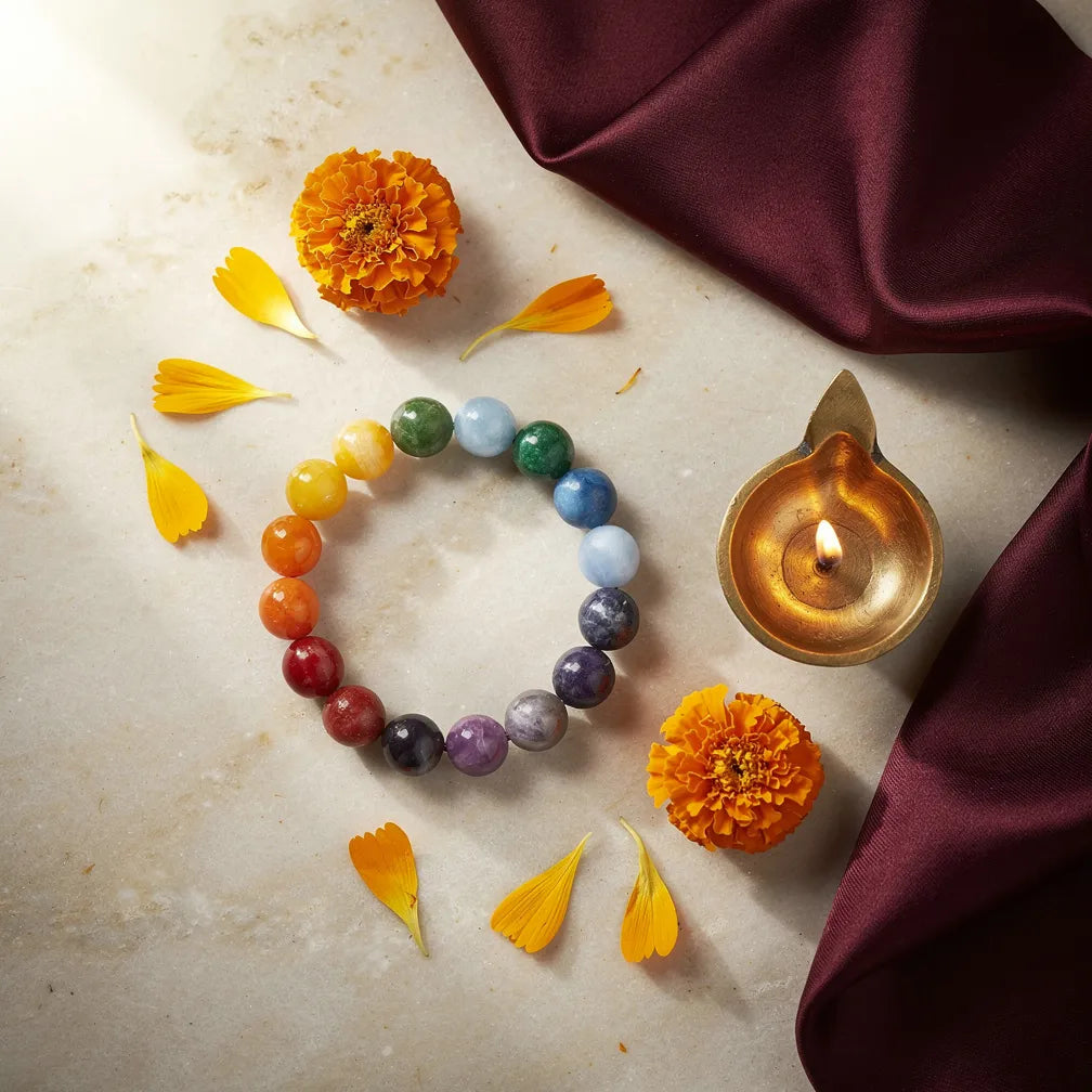 Seven Chakra Band with diya and marigold — ritual flat-lay | Salico