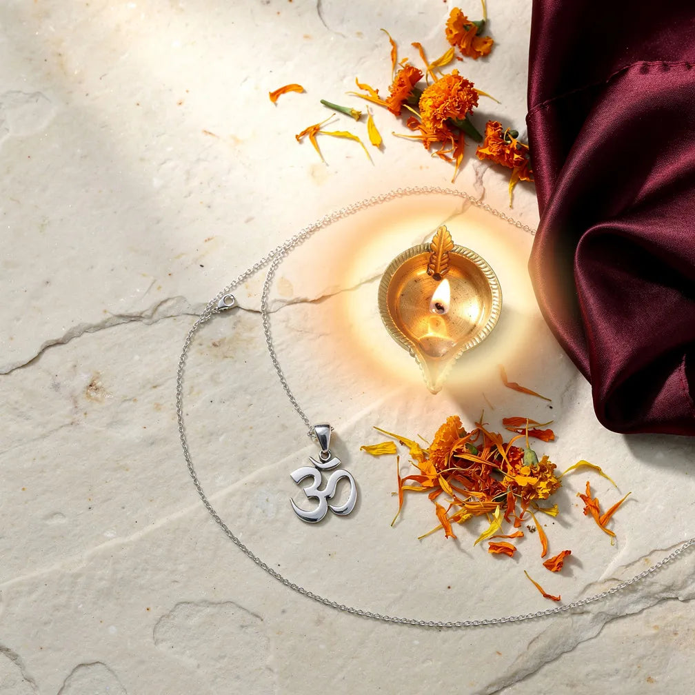 Om Pendant with diya and marigold — ritual flat-lay | Salico