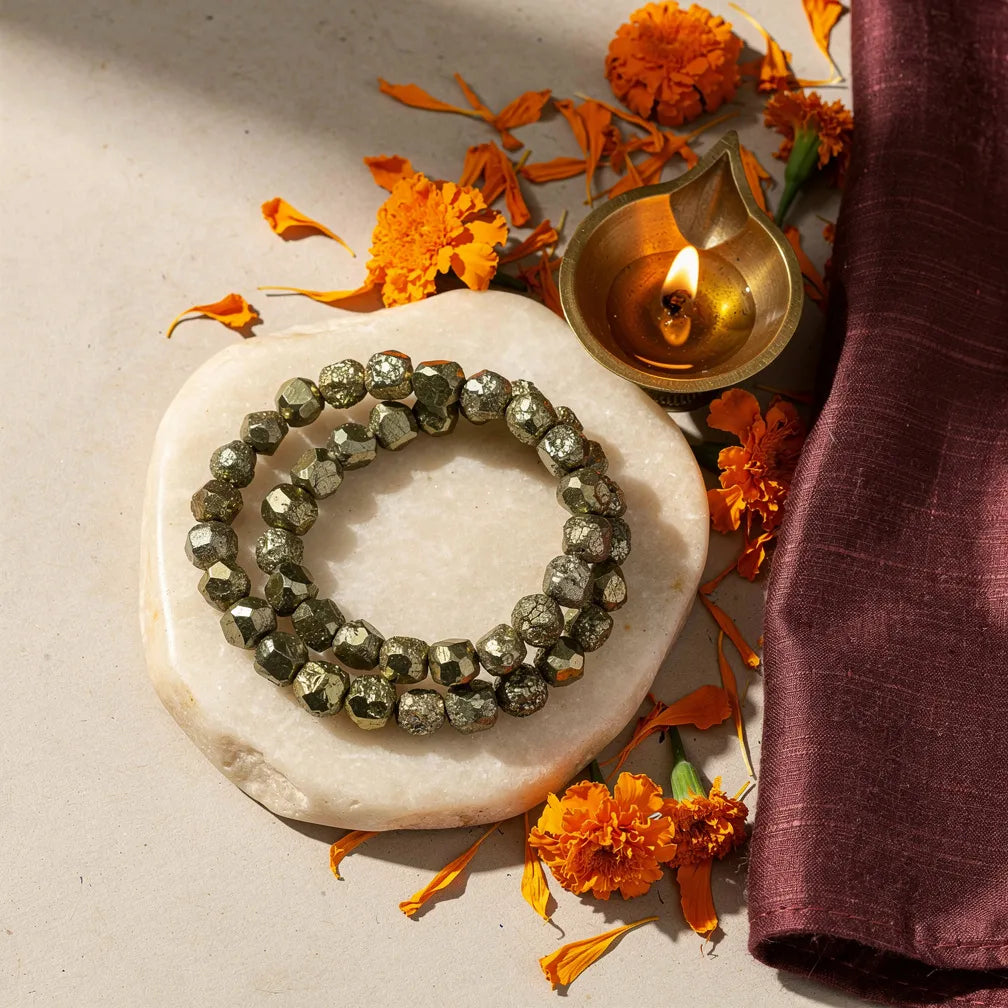 Pyrite Bracelet with diya and marigold — ritual flat-lay | Salico