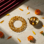 Citrine Band with diya and marigold — ritual flat-lay | Salico