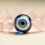 Evil eye charm and rose quartz close-up | Salico
