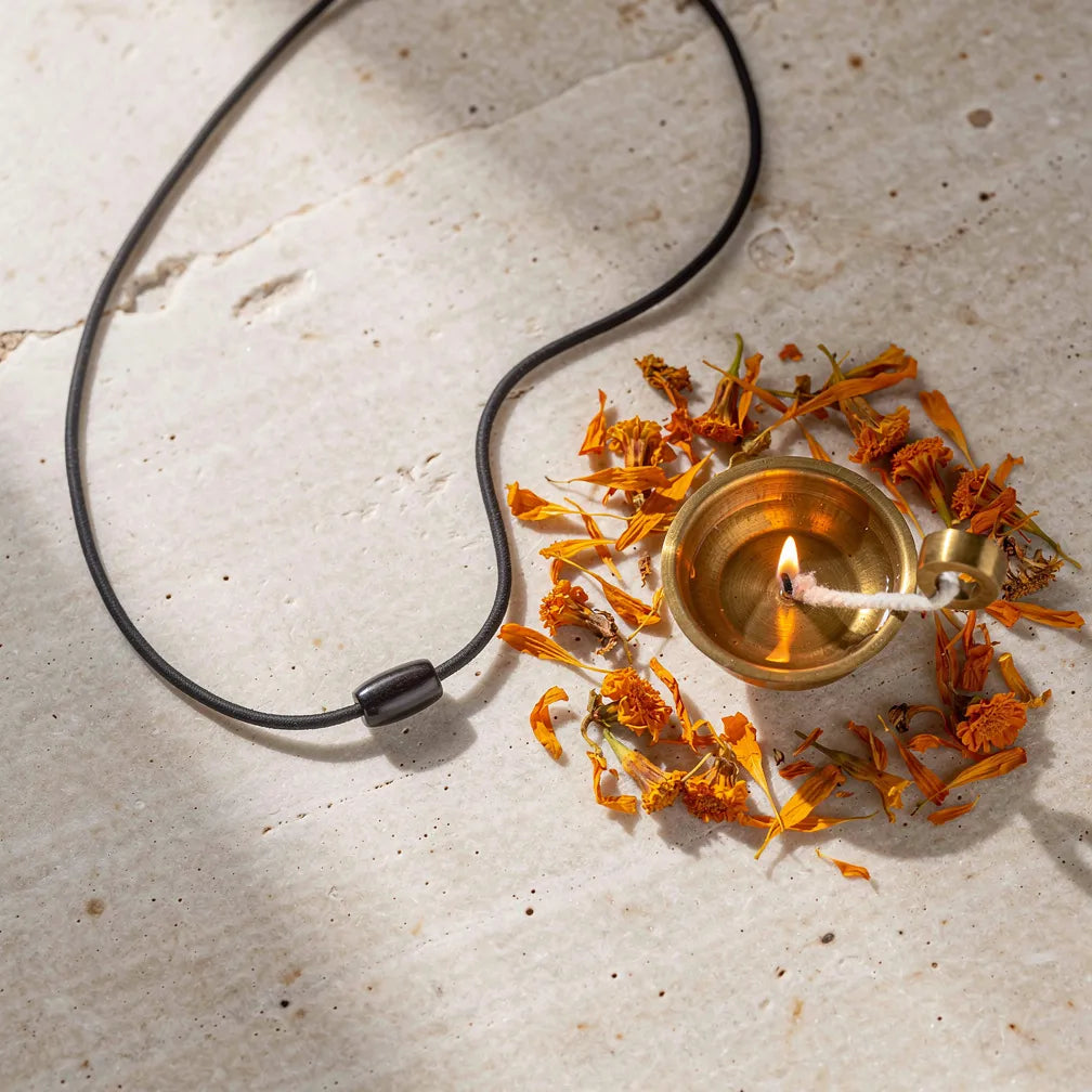 Karungali Minimal Pendant with diya and marigold — ritual flat-lay | Salico